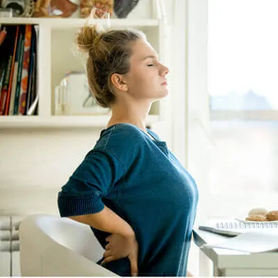 Woman holding back in pain