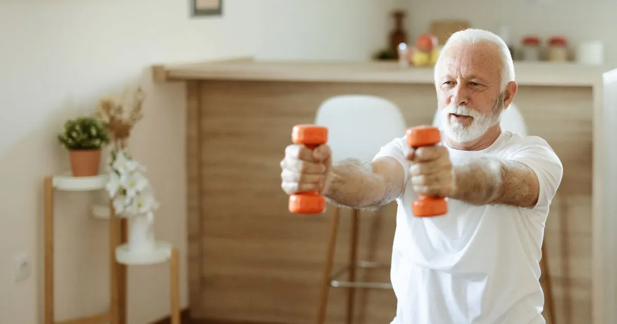 Older man lifting arm weights.
