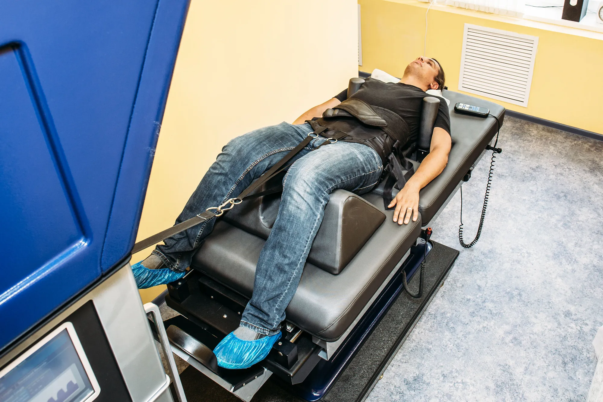 Patient lying on a spinal decompression table