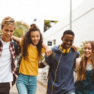 Teens walking arms on shoulders