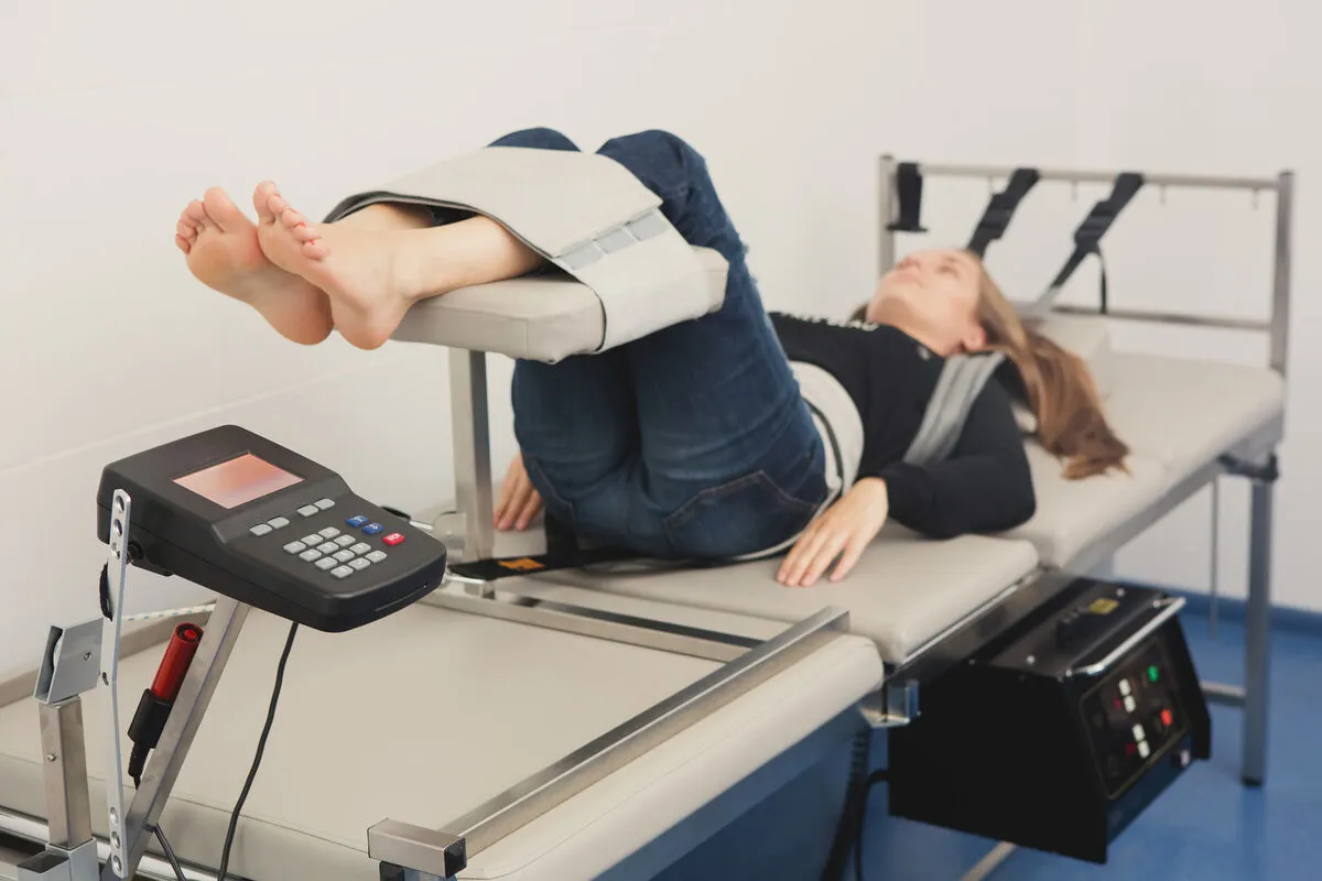 Woman receiving spinal decompression traction therapy