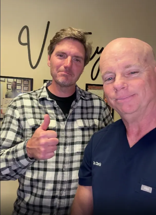 Dr. Christopher Quigley working with male patient
