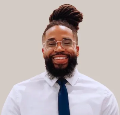 Smiling man in a white shirt and navy tie